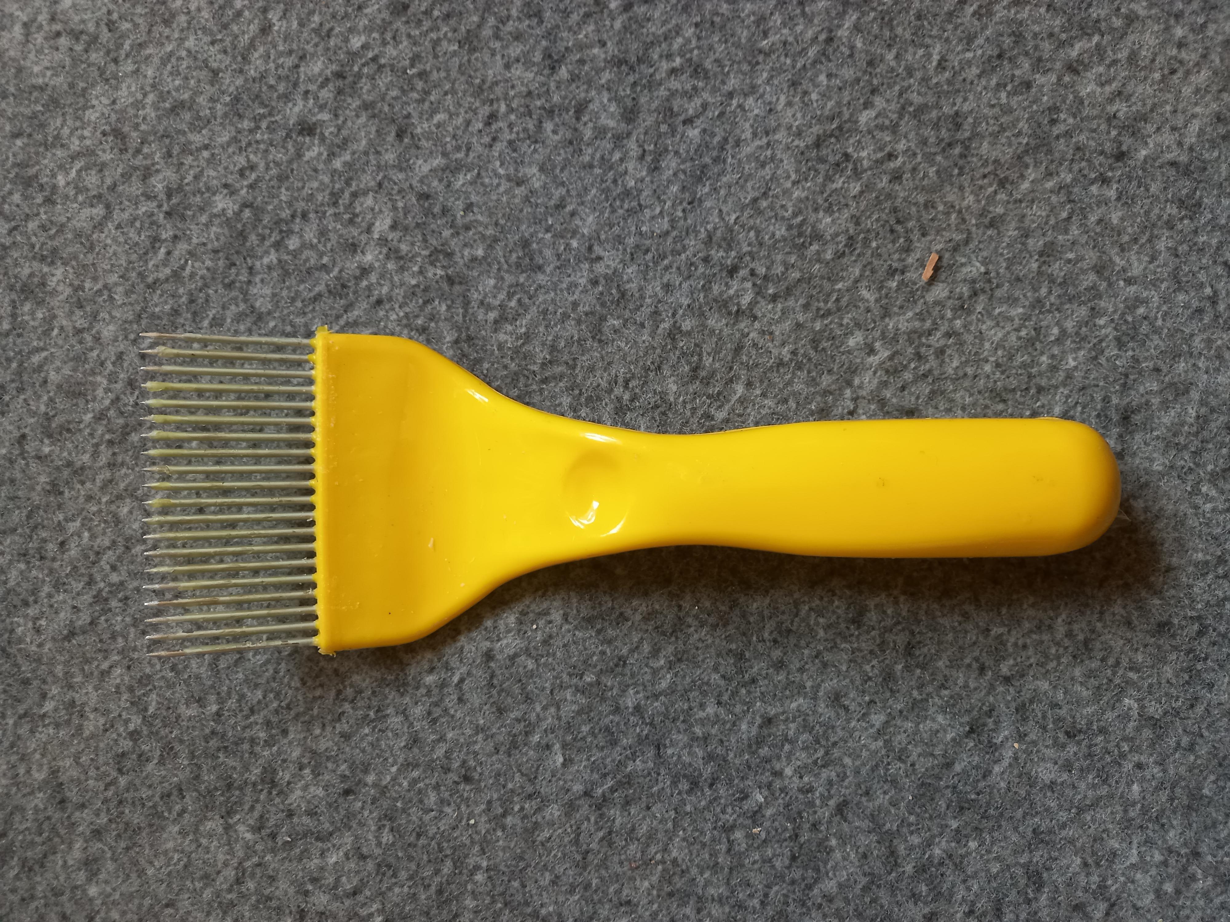 Honeycomb uncapping brush in Ghana image