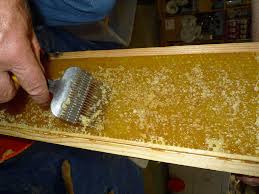 Honeycomb uncapping brush in Ghana image